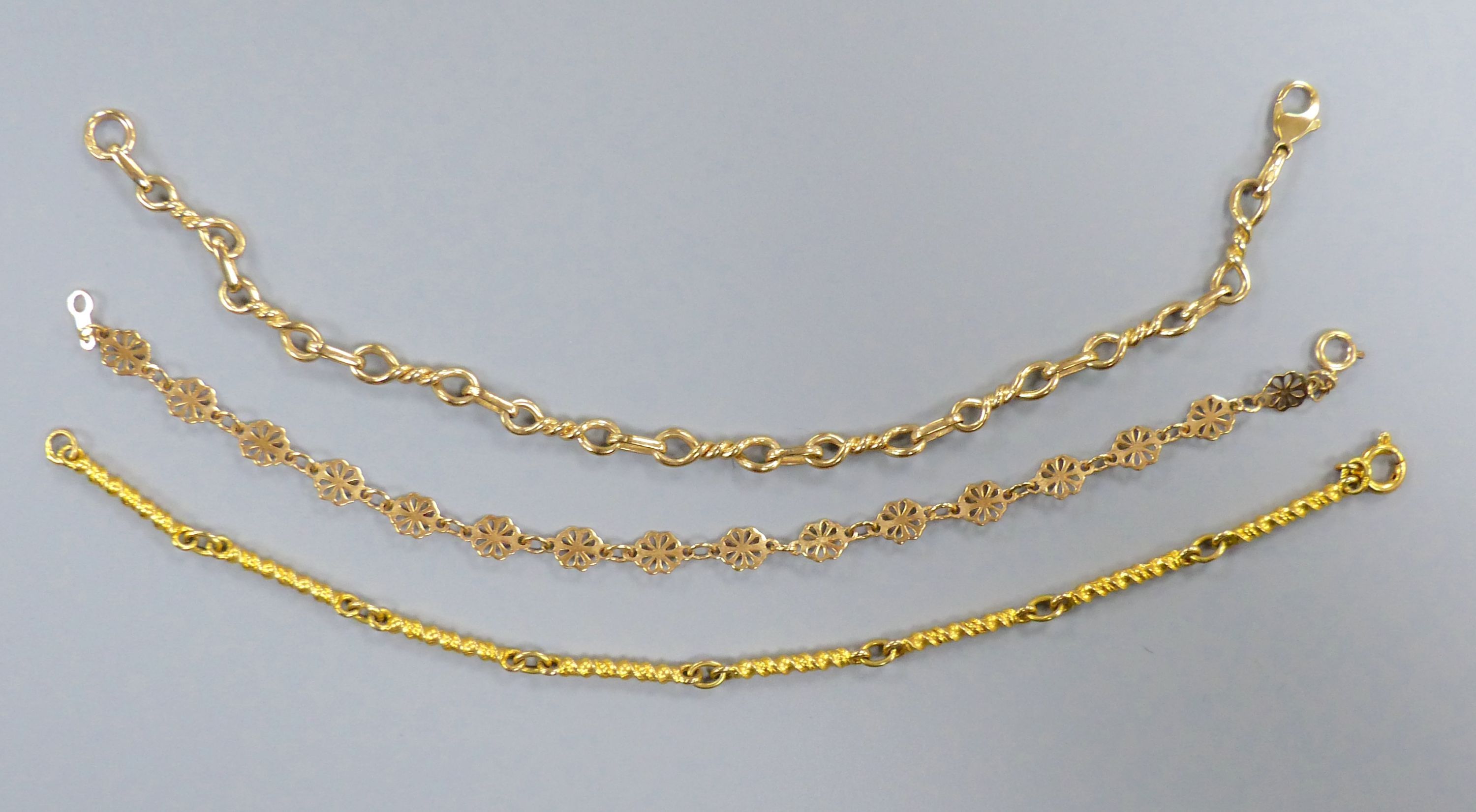 Three assorted modern 9ct gold bracelets, longest 19cm,